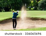 Thai young man golf player in action swing in sand pit during practice before golf tournament at golf course