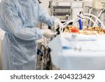 Small photo of In the operating room, a veterinary surgeon performs a major operation on an animal. An experienced surgeon accurately performs a complex operation on an animal. Veterinary surgery.
