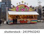 Small photo of Eindhoven, the Netherlands. 7 January 2023. Gebak stall. A pastry stall is a stall where fried dough dishes are prepared and sold, such as oil and raisin buns, Berliner buns, apple fritters and waffle