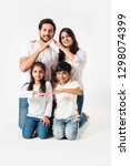 Small photo of Indian family making the home sign over white background. selective focus