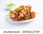 Small photo of Paneer tikka is an Indian dish made from chunks of cottage cheese marinated in spices and grilled in a tandoor