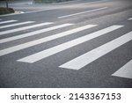 Small photo of pedestrian crossing, white stripes on black asphalt, road markings zebra crossing, place to cross the road, traffic rules