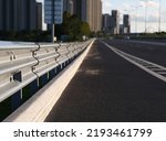 Small photo of Traffic barrier on bridge highway road. Median crash barriers for protect vehicles from accident. Industrial city background.