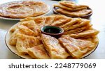 Small photo of Feteer meshaltet - Feteer (Egyptian Pie), It consists of many thin layers of dough and ghee and an optional filling. The fillings can be both sweet or savory.