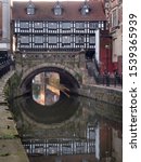 Small photo of Lincoln, Lincolnshire/UK - 09.14.2019: River Witham flows under High Bridge, also known as the Glory Hole. High Bridge is a medieval bridge with shops on it and the largest of its kind in Britain.