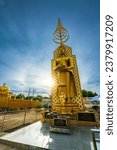 Small photo of PHITSANULOK, THAILAND - October 2,2023:Sun halo with blue sky with Buddha statue at in Temple (Thai language:Wat Chan West) is a Buddhist temple It is a major tourist attraction Phitsanulok,Thailand