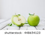 Green fresh apples on wooden table close up, rustic style, selective focus