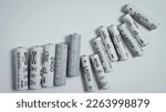 Small photo of AA and AAA size nimh batteries on a white background. Several batteries in a row. Space for text. Ikea Ladda NiMH rechargeable batteries. Orel, Russia - Feb 18 2023.