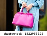 Pink leather bag in female hands. Stylish modern and feminine image, style.  Bag close up.
