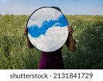 Small photo of Sky reflexion in mirror on spring field