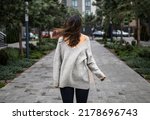 windy weather, hairs close woman's face, sad mood and cold weather. young woman on a windy day. wind blowing hair.
