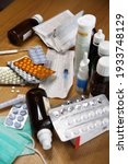 Small photo of Various medicines with annotations, syringes and medical masks on table