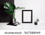 Stylish feminine space with monstera leaves in vase, cactus, notebooks, candle at home or studio with white and black background on shelf. Isolated mockup frame. Styled minimalistic still life