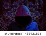 Hacker with dark hoody in red and blue light in front of a spherical network darknet concept