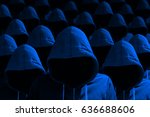 Group of hooded hackers with side light in blue cybersecurity concept