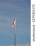 Small photo of Pontianak Indonesia, March 22, 2023, the red and white flag flutters mightily in the clear blue sky. Red and white is the national flag of Indonesia