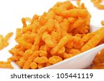 A Bowl With Cheese Puffs On A...