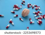 Concept of brain diseases, mental health, Alzheimer's, Parkinson's disease, dementia, stroke, and seizure. Nootropics use to improve memory and neural function. Brain model with a pills.