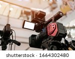 Small photo of Media Television film Production and interview reporter concept: Video recorder movie recording films shooting of grand opening in conference hall live event streaming for presentation by videographer