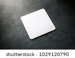 Small photo of Blank white square beer coaster mockup lying on the textured background. Squared clear design mock up top view. Quadrate cup rug display, isolated.