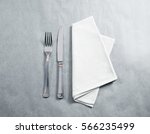 Blank white restaurant napkin mockup with knife and fork, isolated. Cutlery near clear textile towel mock up template. Cafe brand identity overlay surface for logo design.