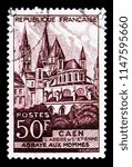 Small photo of MOSCOW, RUSSIA - MAY 17, 2018: A stamp printed in France shows Caen - The Abbey men, The church of Saint Etienne, Tourism serie, circa 1951