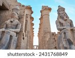 Small photo of Seated statue of Ramesses II by the First pylon of the Luxor Temple, Egypt. Columns and statues of the Luxor temple main entrance, first pylon, Egypt