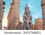Small photo of Seated statue of Ramesses II by the First pylon of the Luxor Temple, Egypt. Columns and statues of the Luxor temple main entrance, first pylon, Egypt