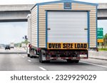 Oversize over size load hauler truck trailer vehicle hauling mobile module home house on North Carolina interstate highway road