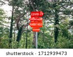 Small photo of Covid-19, Adrenochrome, Rabbit Hole, Lockdown road warning red signs. Social media campaign for coronavirus plus fake news and total disorientation in society. Conspiracy theories concept