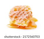 Small photo of Honeycomb with honey drop on white background