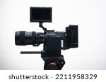 4k Digital Cinema Camera on a Tripod with a 50-100mm F1.8 Zoom Lens Compact white background