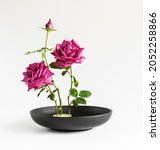 Ikebana Of Roses In A Black...