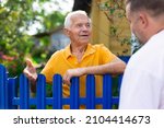 Small photo of Old man talking with his neighbour