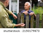 Small photo of Senior man having conversation with his neighbour