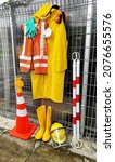 Small photo of Personal protective equipment like safety vest, protective visor, raincoat, rubber gloves, safety goggles, ear muffs, safety face mask and rubber boots. Safety cone, blinker light and poles.