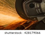 Small photo of Sparks from cutting metal abrasive disk of angle grinder. Industrial concept.