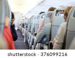 Small photo of Passengers are sitting and sleeping on an airplane. They get stuck in their seat in a long and boring flight.