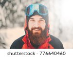 Portrait of happy young man with beard in snowy forest. Smiling man with beard in winter time. Winter mood. Sport man hiking in mountains. winter sport.