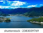 Small photo of Lake Kawaguchi located in town of Fujikawaguchiko lake near Mount Fuji, Japan. Stunning views of landscape, citiscapes and skyscapes besides the lake itself surrounded by mountains and beautiful banks