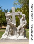 Small photo of Santa Inez, CA, USA - April 3, 2009: San Lorenzo Seminary. Station of the Cross number 2 white marble statue. Jesus takes up his cross. Under blue sky with green foliage in back.