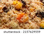 Small photo of cous cous with dried fruits saffron and nuts depraved close-up. horizontal photo
