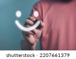 Man writing Happy smiley face,Customer service Satisfaction, good feedback rating,positive customer review,experience, satisfaction survey,mental health assessment,wellness,world mental health concept