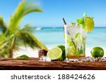 Mojito drink on wood with blur beach background