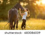 Young woman with her horse in...