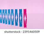 colorful wooden clothespin - abstract vision of man and woman. standing out from the crowd, leadership, difference concept. personality struggle for equality
