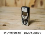 Small photo of Kajang, Malaysia- February 8, 2018 : Nokia 8310 Mobile Phone, One of the smallest Nokia handsets which included an FM radio, launched in 2000 on wooden background.