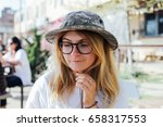 Small photo of Cute petite female in panama hat and round glasses is ready to explore new horizons and embark on adventure of lifetime during summer spring break vacation