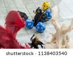 Small photo of Krasnodar, Russia, July 19, 2018: Playing Dungeons and Dragons. Miniature fugures of rpg characters, skeleton in a cloack holding a sythe, dices and dragon