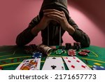 Small photo of Devastated gambler man losing a lot of money playing poker in casino, gambling addiction. Divorce, loss, ruin, debt, ludopata concept.